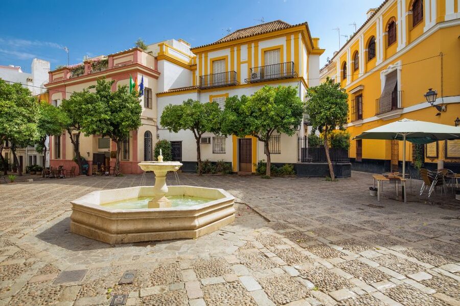 Seville: Relaxing City Bike Tour with a Tour Guide - The tobacco factory and the story behind the facades