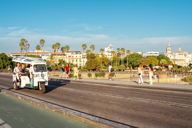 Tour Welcome Seville with Local Guide in Eco Tuk Tuk Private - The riverfront, Torre del Oro and Maestranza